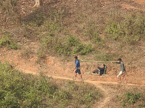 Villagers taking an injured person to a health centre 25 kilometres away. Photo: Bhabesh Medhi