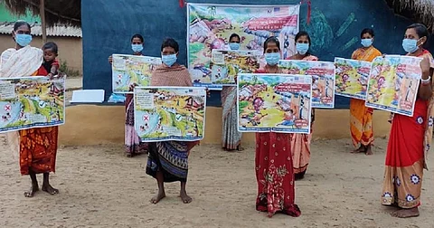 Distribution of posters and banners on containing the spread of COVID-19 at Kendupada village in Boipariguda block under Koraput district of Odisha. Photo: Manas Mohanty