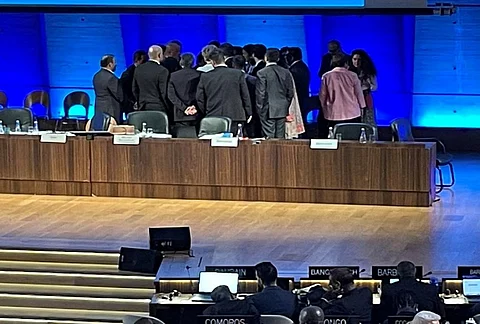 Member states huddle for a 15-minute consultation. Photo: Siddharth G Singh