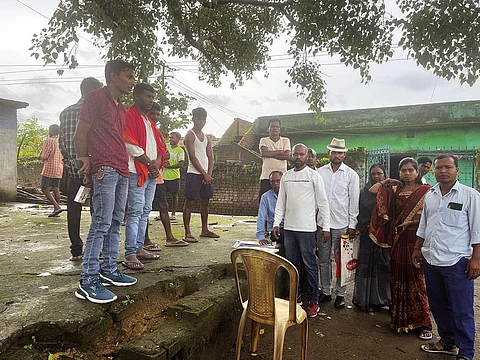 Mukesh Rajwar (wearing hat), Ravindra Kumar (centre) and his wife Chhaya (in brown saree), of Ichakdih village await employment in lieu of their land  that the government acquired tor coal mining a decade ago (Photographs: Sukriti Vats)