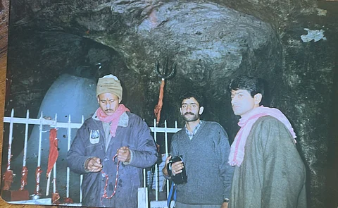 Ashraf Wani at the centre with the massive Ice Lingam in the background, August 1998.