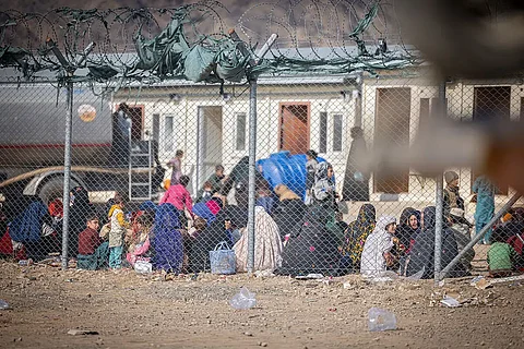 Afghan returnees at a temporary shelter before heading to the IOM Transit Centre in Kandahar