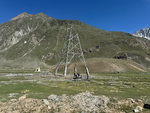 A power transmission tower lies damaged on way to Zojilla pass due to heavy snowfall during winter period.