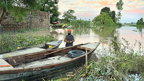 Farmer Sukhwinder Singh uses a wooden boat to commute in his village, Fatehgarh Sabrah, near Harike town, after the recent floods. The inundation has completely destroyed Singh’s vegetable fields. He saw similar damage in 2023, leading to huge crop losses