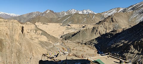 Snowless slopes surround Lamayuru village, where the mountains remain largely bare this winter, reflecting the unusually low snowfall across parts of Ladakh.