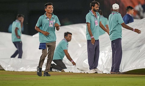 Groundsmen cover the pitch as it rains before the start of the Indian Premier League (IPL) 2025 Qualifier 2 cricket match between Mumbai Indians and Punjab Kings, at the Narendra Modi Stadium, in Ahmedabad (PTI)&nbsp;