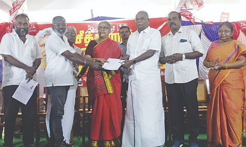 CPM polit bureau member K Balakrishnan handing over a will to donate his body at Yechury’s death anniversary event on Friday