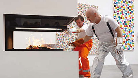 The Turner prize winner and assistants used tongs to deposit individual pieces stacked in piles into fireplaces in the gallery