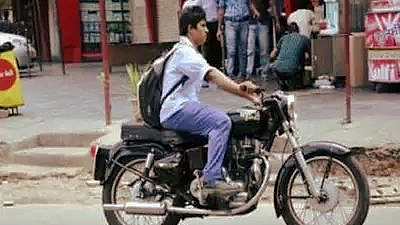 Children are seen riding two wheeler