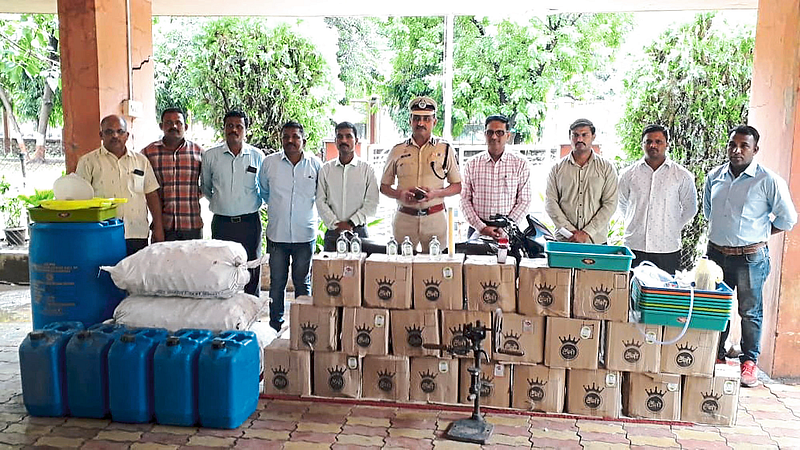 Praveen Kumar Patil, Hemant Patil and LCB team present with counterfeit liquor seized by LCB.