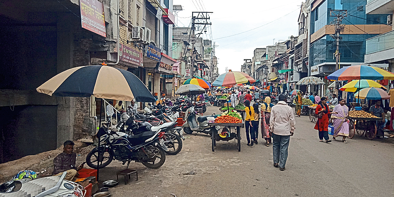A street lined with hawkers on busy Agra Road