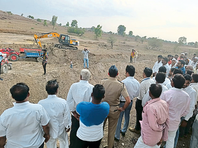 Collector Abhijit Raut and villagers inspecting the ongoing works by JCB for Amrit Sarovar.