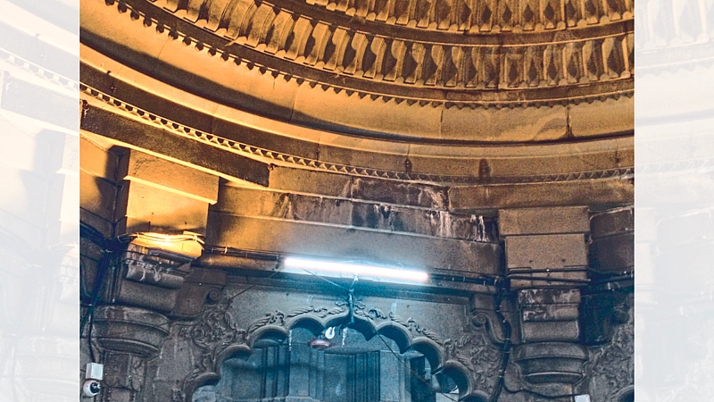 A layer of white paint has risen to the top of the temple due to water seepage.