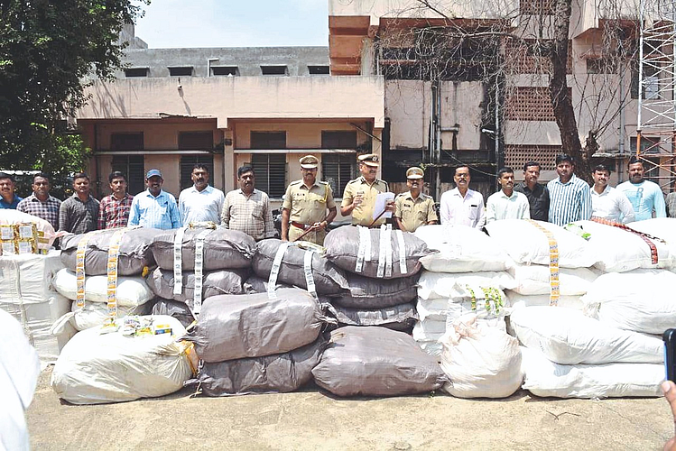 Police officers and action team inspecting gutkha seized by LCB