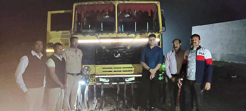 Collector Aman Mittal, Tehsildar Namdev Patil and revenue staff with the dumper seized in the area.