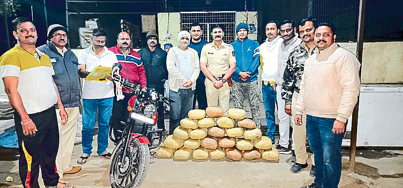 Police Inspector Jaipal Hire along with seized ganja and other items. Other officers and police personnel in the neighborhood