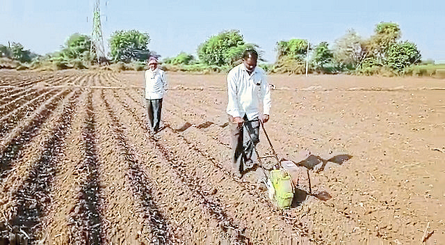 Rajendra Patil while sowing wheat with tiller