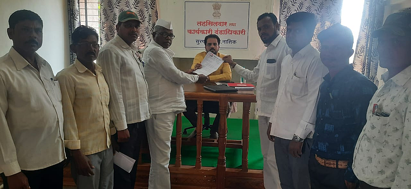 Taluka President of NCP Chitaman Gavit while presenting the statement of demand to Surgana Tehsildar Sachin Mulik.