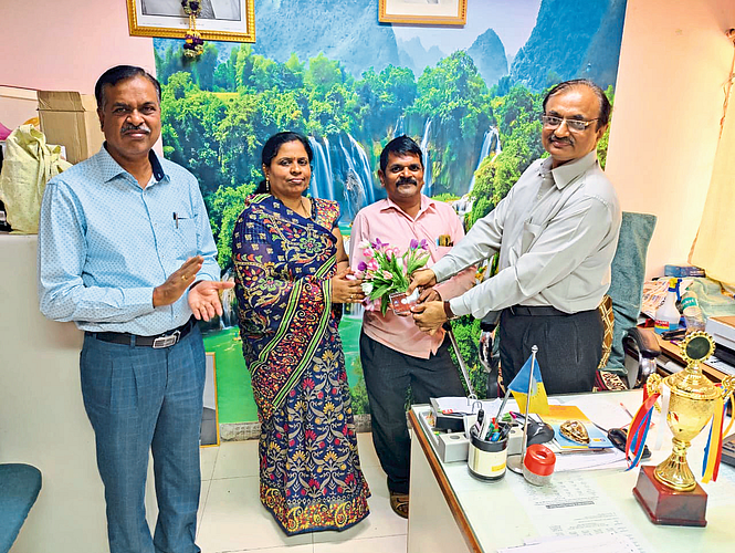 Insurance officer handing over Malaysia study tour letter to Divyang Nimba Sawant's wife Sunita Sawant.