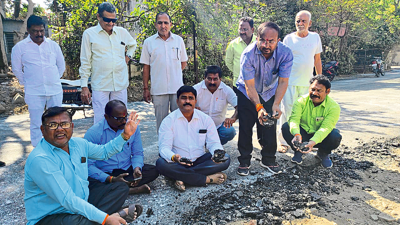 Dhule: Shiv Sena office bearers and workers demolishing the asphalt layer on the road between Gitanagar and Green Top