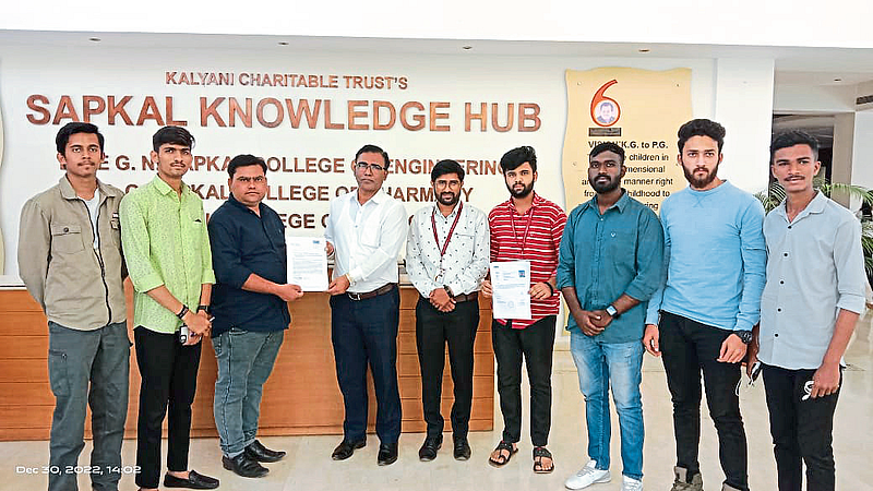 Kalyani Charitable Trust's Sapkal Knowledge Hub, Engineering College Principal Dr. S. B. Bagal Yin's Divisional Officer Ganesh Jagdale while handing over the election brochure.