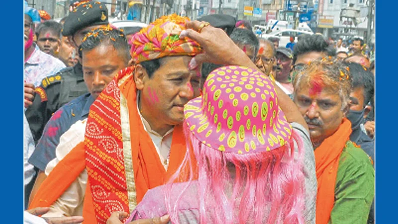 गुवाहाटी - आसामचे मुख्यमंत्री सर्वानंद सोनोवाल यांना सोमवारी प्रचारफेरीदरम्यान रंग लावताना नागरिक.