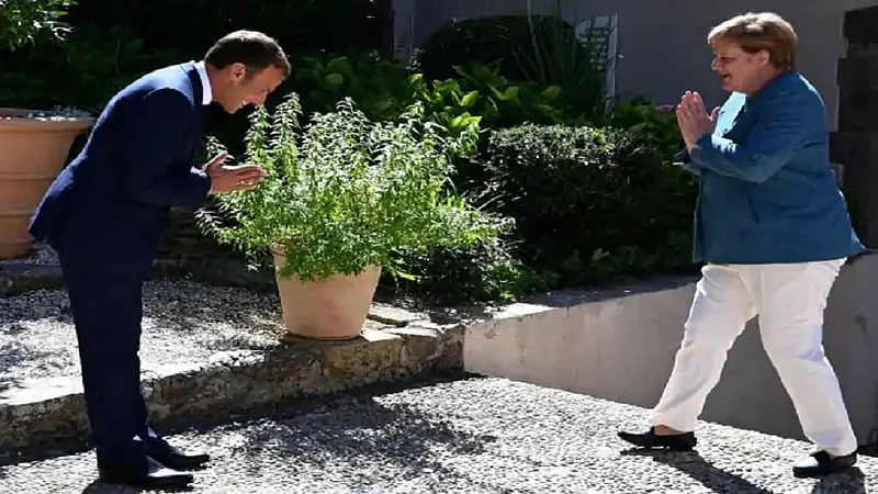 emmanuel macron greets angela merkel namaste
