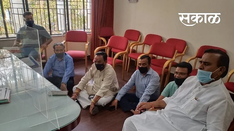 Traders sit in in the administrators hall for agitation in market yard