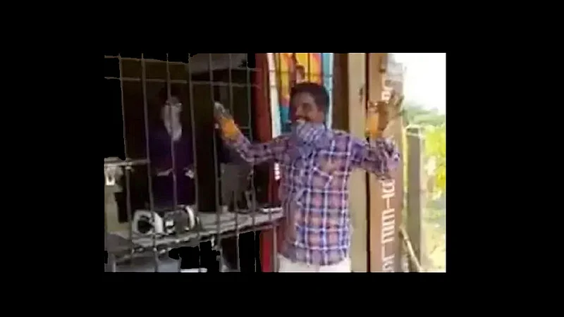 man started dancing when he got liquor bottles after long wait in the queue outside the shop