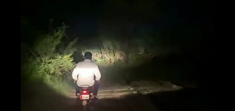 Minister Tanpur travels by bike on a narrow forest road in remote areas