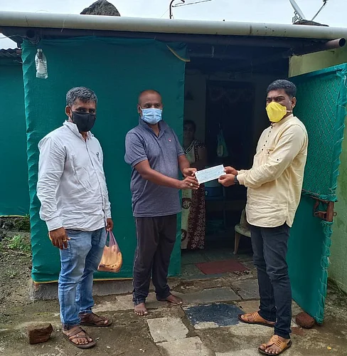 A check of Rs 51000 for assistance to a person from Nandur Pathar