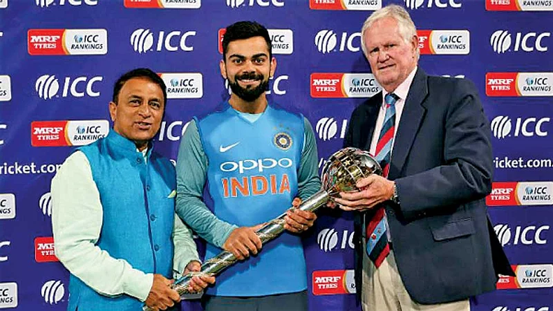 केप टाउन - कसोटी क्रिकेटमधील अजिंक्यपदचा करंडक सुनील गावसकर (डावीकडे) आणि ग्रॅमी पोलॉक (उजवीकडे) यांच्या हस्ते स्वीकारताना भारताचा कर्णधार विराट कोहली.