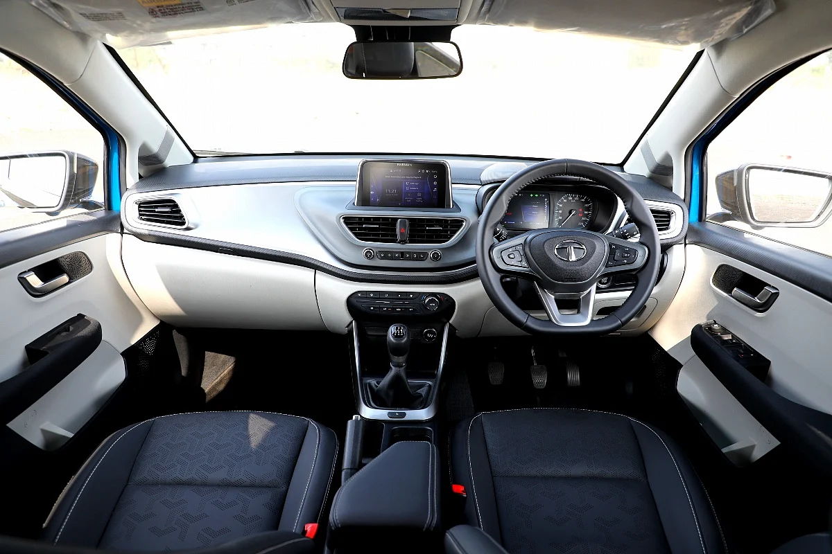 Light grey plastics and leatherette seats improve the experience inside