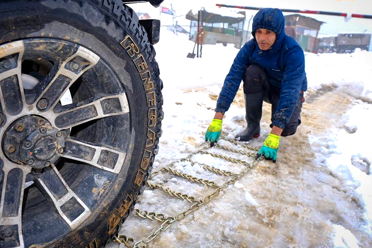 Putting on snow chains