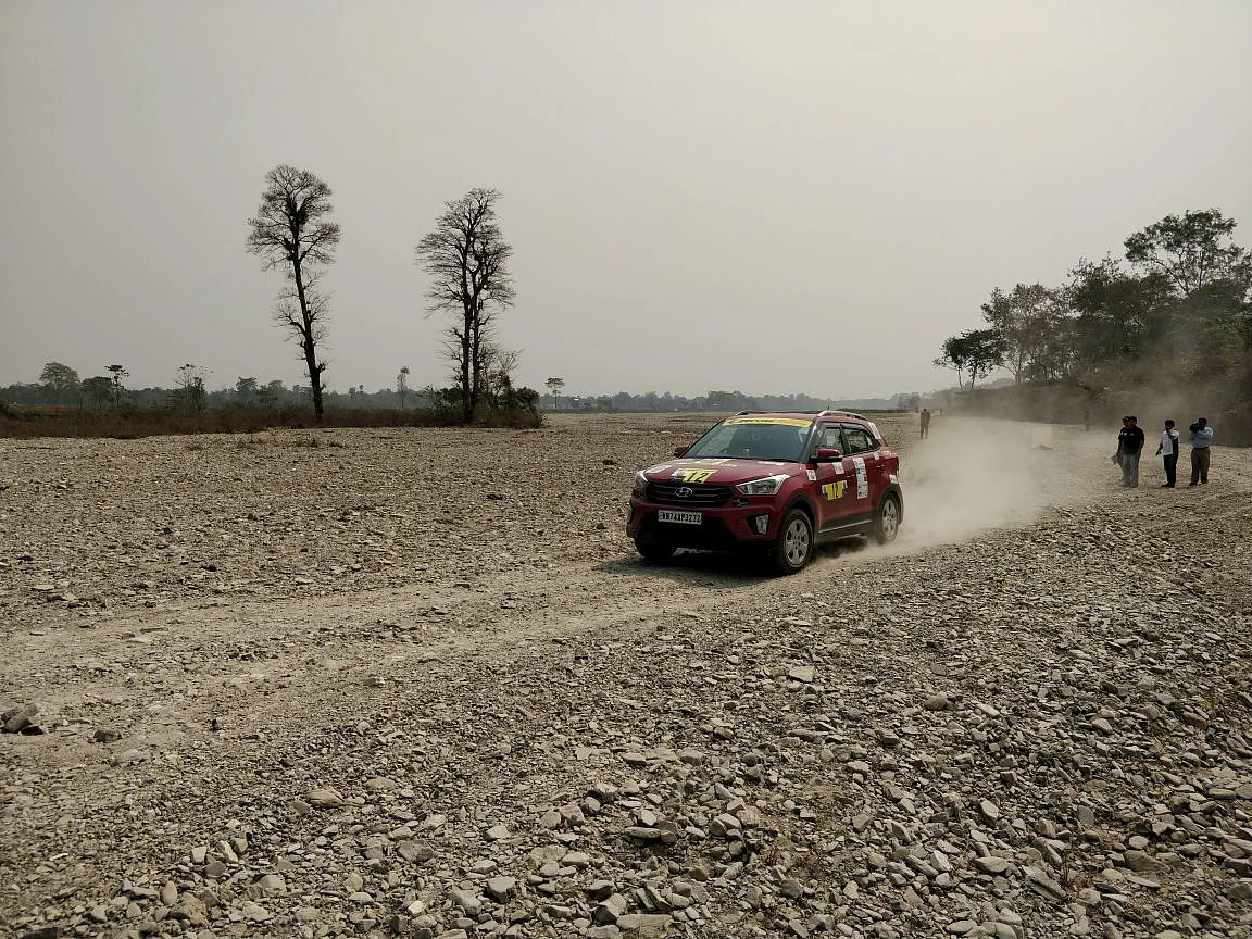 Participants cross a riverbed outside of Siliguri
