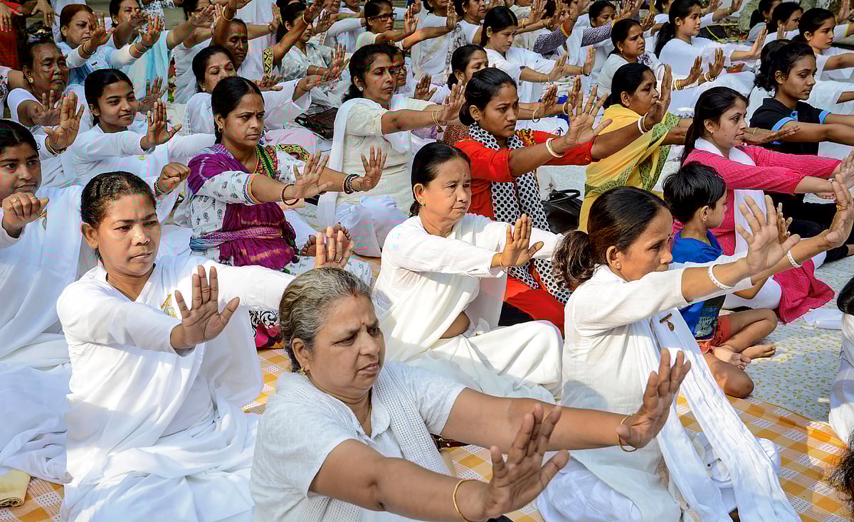 Women take part in a mass yoga session to mark the 5th International Day of Yoga, in Guwahati