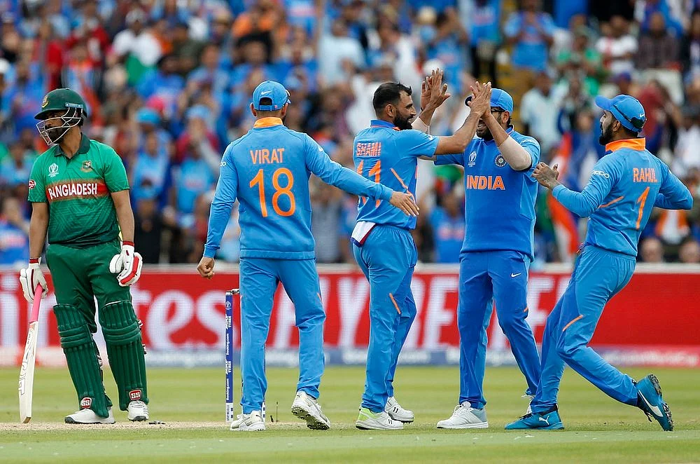 Indian bowler Mohammad Shami celebrates with teammates the dismissal of Tamim Iqbal during a match against Bangladesh in ICC CWC 2019 at Edgbaston in Birmingham on Tuesday