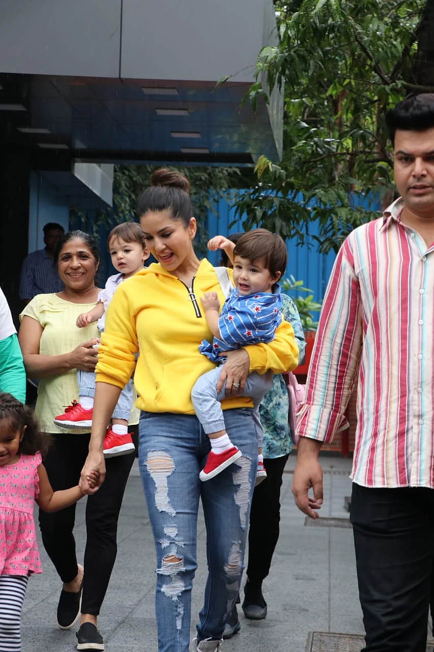 Sunny Leone was spotted with kids Nisha Kaur Weber, Noah and Asher at a play school in Juhu. In yellow sweat shirt and blue jeans the actress looked her usual chilled out self.
