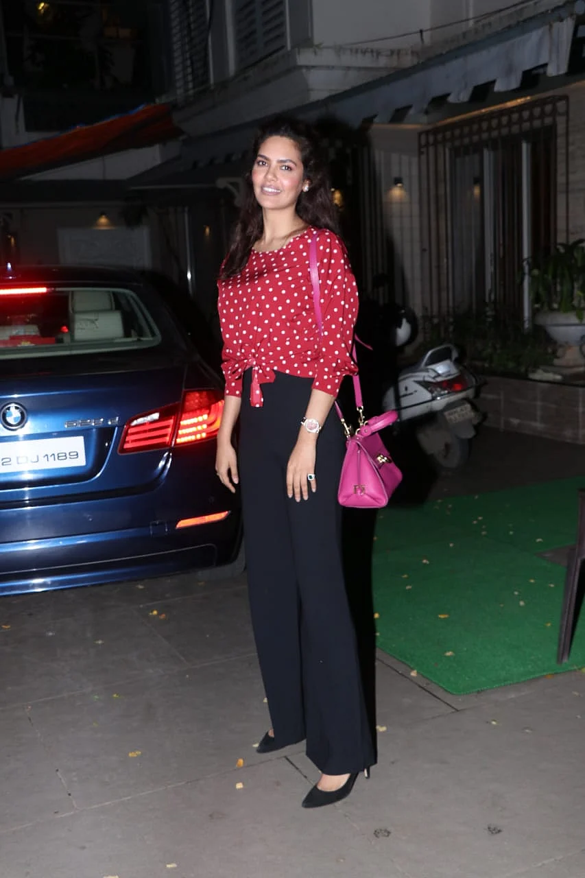 Esha Gupta was clicked by paps in the city, she was all smiles to camera in red and white polka dot crop top with pink handbag.