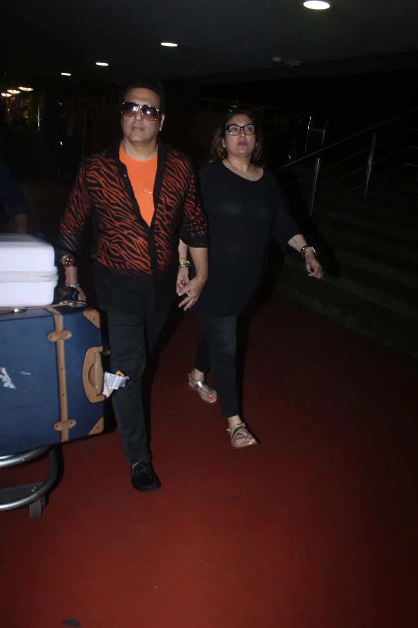 Actor Govinda in his iconic style outfit, Orange tshirt under black striped sher shirt