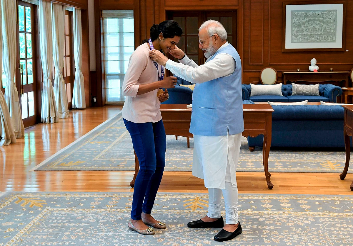 Prime Minister Narendra Modi congratulates World Champion PV Sindhu for her win in the badminton World Championships during a meeting, in New Delhi. Sindhu became the first Indian to win the badminton World Championships by beating familiar rival Nozomi Okuhara of Japan in a lop-sided final in Basel