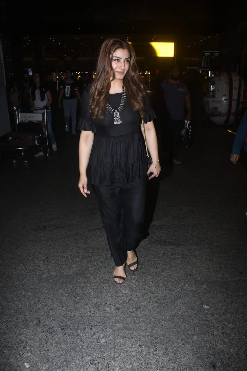 Raveena Tandon was snapped at the airport in an all-black outfit smiling for the cameras.
