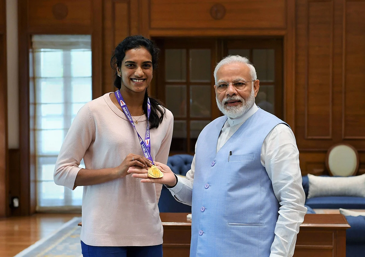 Prime Minister Narendra Modi meets World Champion PV Sindhu, in New Delhi. Sindhu became the first Indian to win the badminton World Championships by beating familiar rival Nozomi Okuhara of Japan in a lop-sided final in Basel