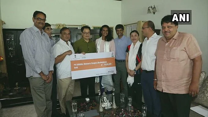 Delhi: Sports Minister Kiren Rijiju met shuttler PV Sindhu, earlier today, and presented a Rs 10 lakhs cheque to her for winning a gold medal in BWF World Championships.