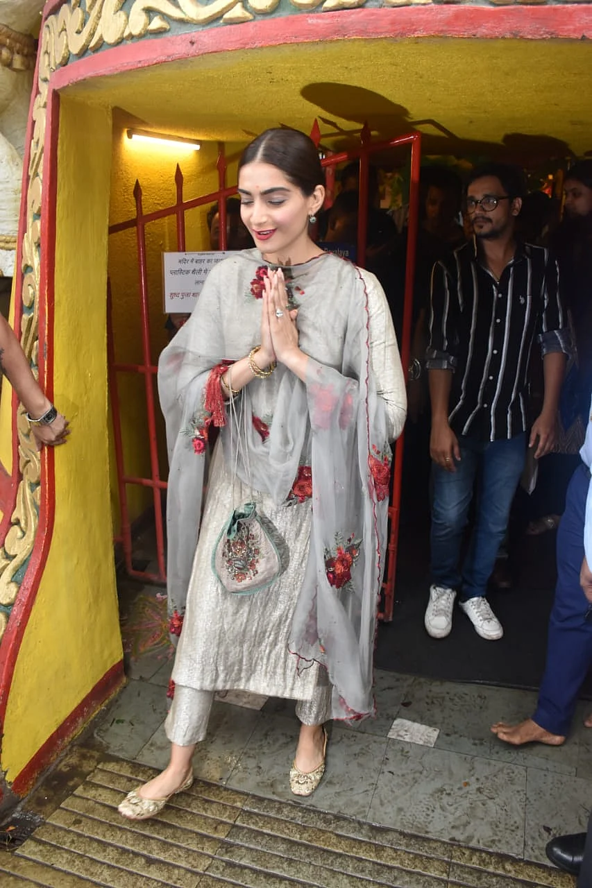 Sonam Kapoor gearing up for the release of 'The Zoya Factor' was snapped at the Shani temple in Juhu wearing a grey salvar suit with red floral design on it.