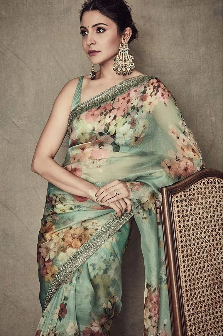 Anushka Sharma is wearing a pastel green floral saree that is one of the suitable greens in trend. Unlike the mundane leafy green, this shade in particular looks royal on couture.
