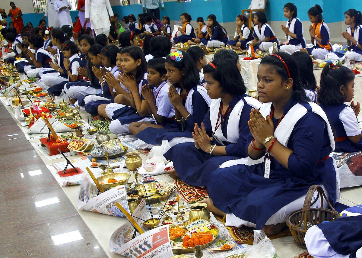 School students offer prayer during the mass worship on the occasion of 'Ganesh Chaturthi' festival in Bhubaneswar