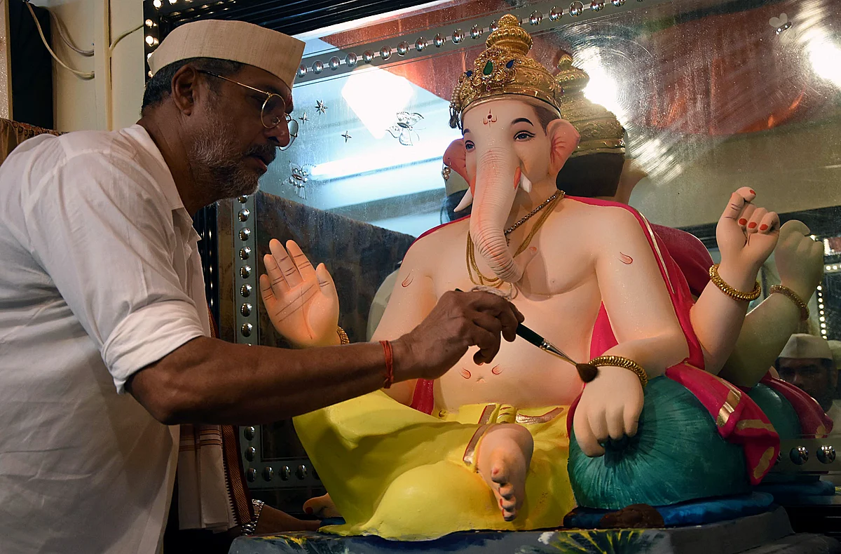 Bollywood actor and social activist Nana Patekar gives a final touch to an idol of Lord Ganesha on the occasion of Ganesha Chaturthi at his residence in Mumbai