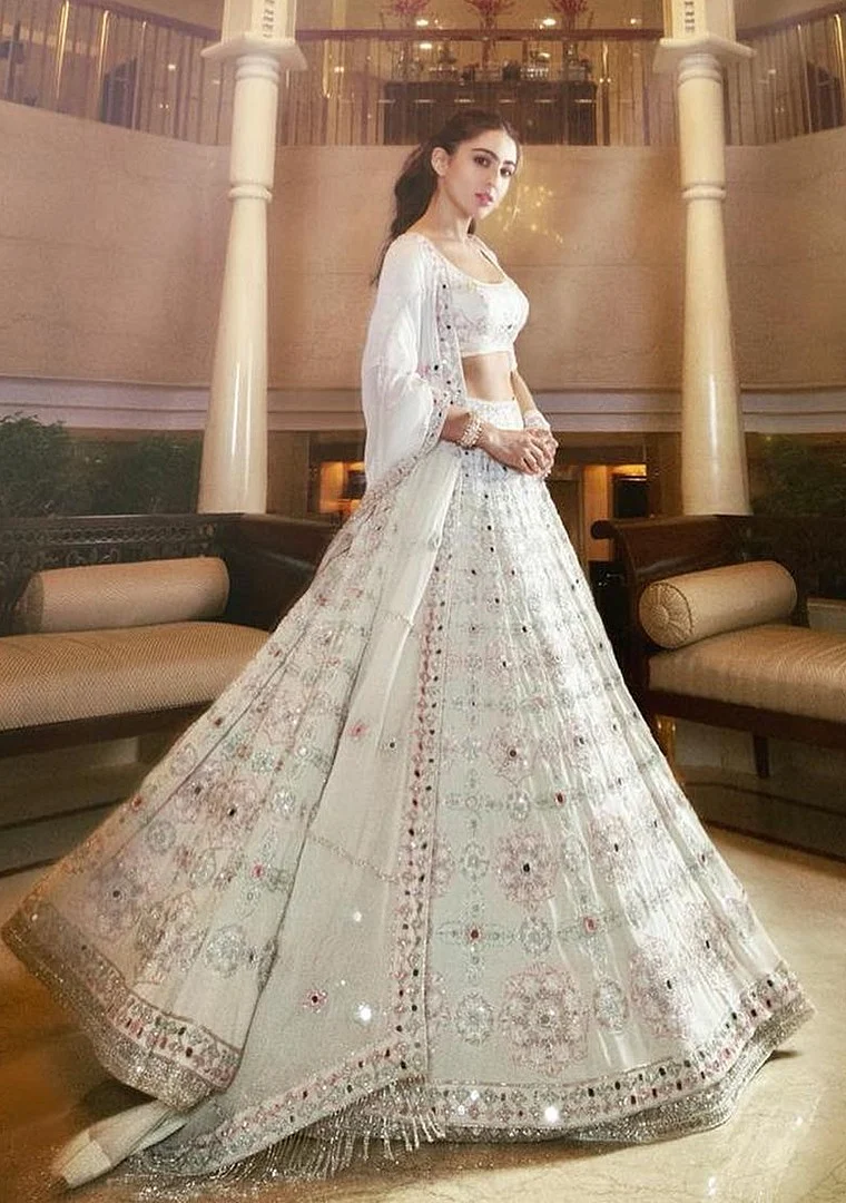 Sara Ali Khan's over the top lehenga choli is sheer elegance. The colour which is a symbol of purity can be enhanced with bold makeup and jewellery.