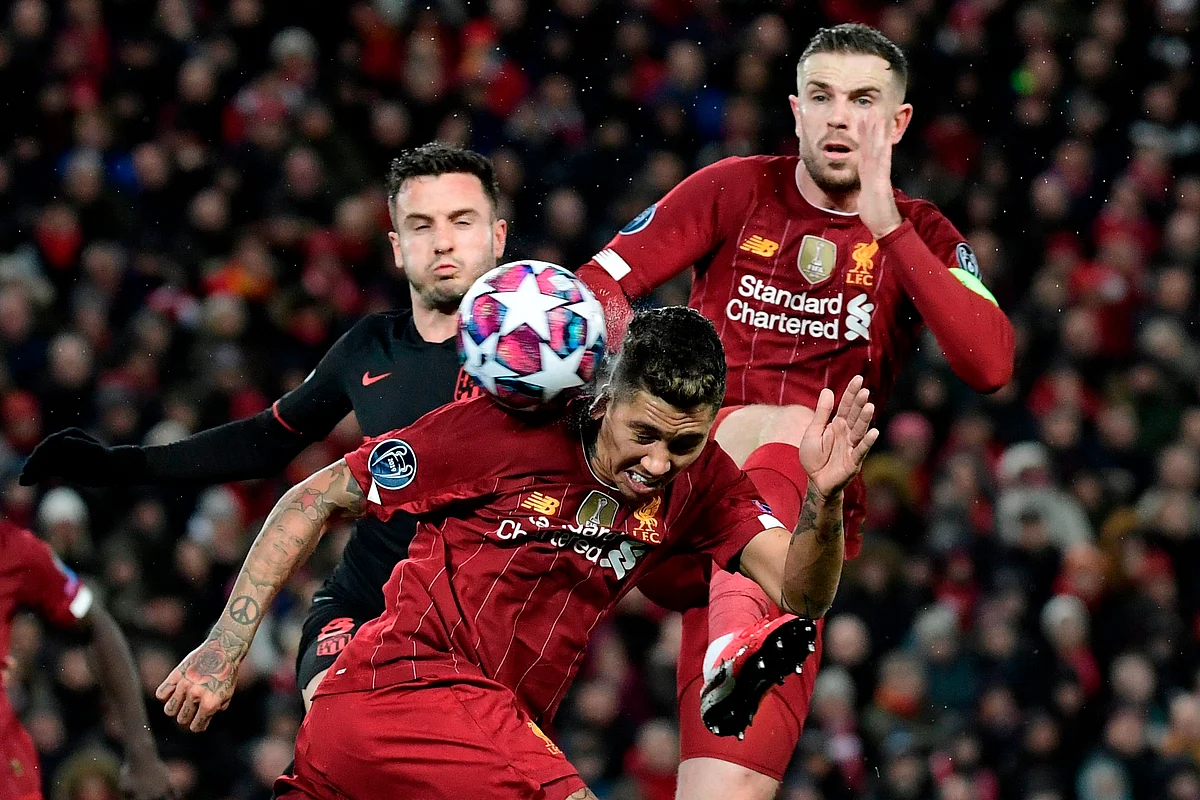 Liverpool's Brazilian midfielder Roberto Firmino (C) controls the ball during the UEFA Champions league Round of 16 second leg football match between Liverpool and Atletico Madrid at Anfield in Liverpool.